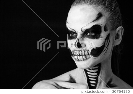 Girl with creative halloween face art on black 30764150