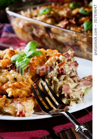 Portion of fusilli pasta casseroles 30769647