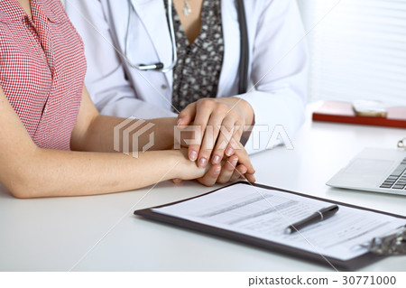 Close-up of doctor reassuring her female patien Close-up of doctor reassuring her female patien 30771000