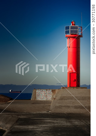 Red lighthouse on breakwater dam Red lighthouse on breakwater dam 30771198