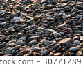 Background with wet shiny stones on the beach 30771289