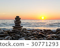 Cairn stones on the beach on sundown 30771293