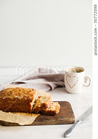 Glazed applesauce oatmeal bread on a white marble  30772099