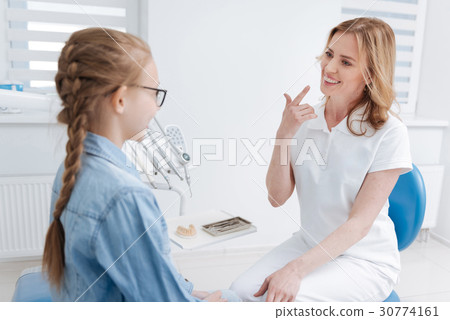 Wonderful attentive dentist showing her braces Wonderful attentive dentist showing her braces 30774161