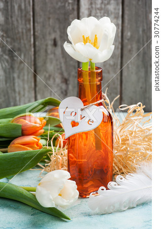 Orange tulips with wooden heart 30774244