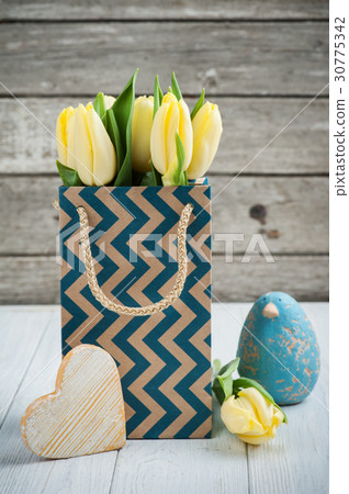 yellow tulips in kraft package 30775342