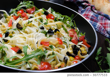 Pasta with olives and tomatoes 30777533