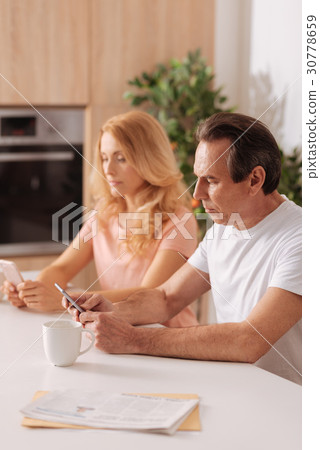 Concentrated mature couple surfing the Internet at Concentrated mature couple surfing the Internet at 30778659