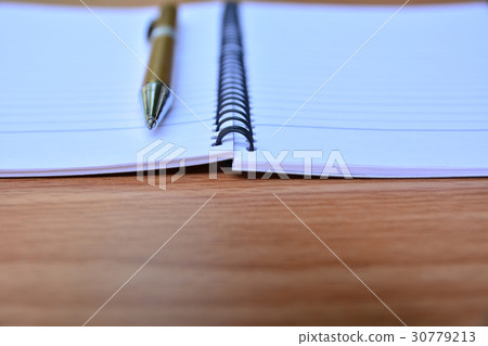Blank memory book with pen on wooden table. Blank memory book with pen on wooden table. 30779213