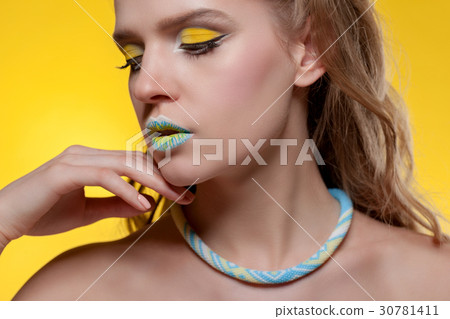 Portrait of a young woman with a creative make-up Portrait of a young woman with a creative make-up 30781411