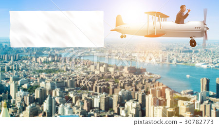 Biplane with businessman and blank banner 30782773