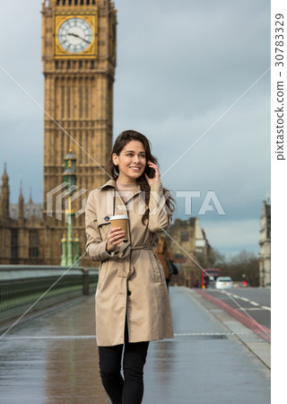 Woman Drinking Coffee Talking on Cell Phone, Big Ben, London, En 30783329