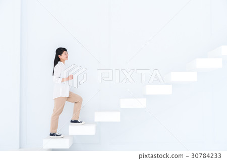 A young woman standing up the stairs 30784233