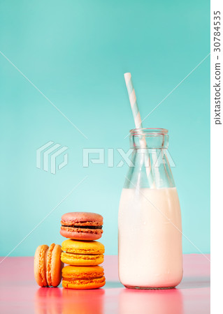 Stack of macarons with botle of milk 30784535