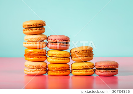 Colorful macarons on bright pastel background 30784536