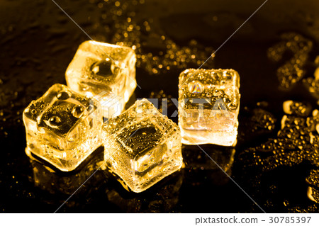 ice cubes and water drop on light golden. 30785397