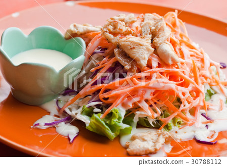 salad with chicken on red plate 30788112