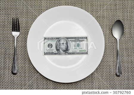 one hundred dollar bill on plate to be eaten 30792760