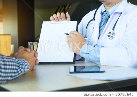 patient listening intently to a male doctor explaining patient s patient listening intently to a male doctor explaining patient s 30793645