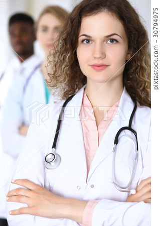 Happy doctor woman with medical staff at th Happy doctor woman with medical staff at th 30794975