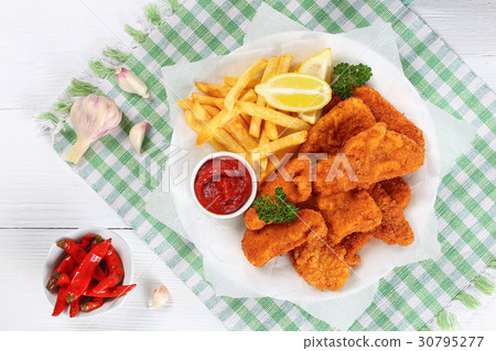 nuggets with tomato sauce,french fries, lemon nuggets with tomato sauce,french fries, lemon 30795277
