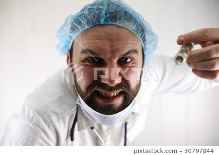 bearded doctor in a white coat and old syringe 30797844