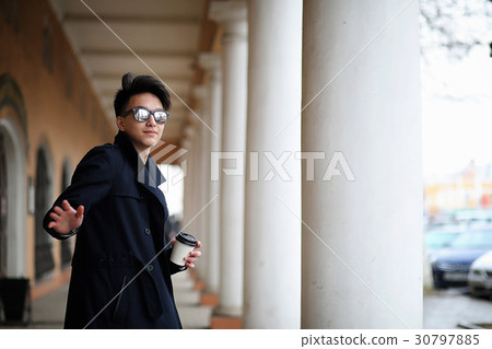 Asian young man in a coat on the street 30797885