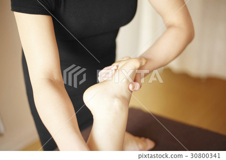 Hand is holding feet. Hand is holding feet. 30800341