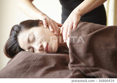 A woman is massaged her neck in spa. A woman is massaged her neck in spa. 30800419