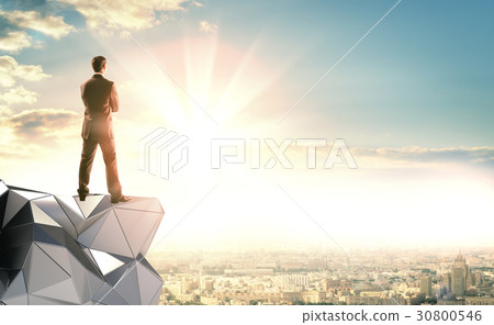 A businessman stands on an abstract construction 30800546
