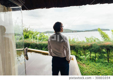 man on beach resort in tropics 30801034