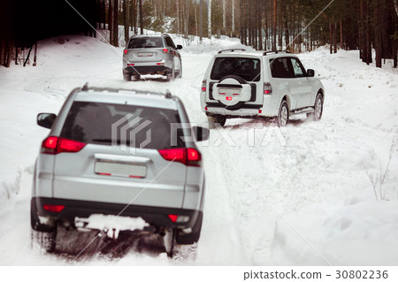 Three SUVs in the woods in winter in the rally Three SUVs in the woods in winter in the rally 30802236