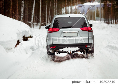 Driving SUV car in winter on forest snow road Driving SUV car in winter on forest snow road 30802240