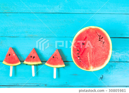 watermelon slice popsicles on a blue wooden watermelon slice popsicles on a blue wooden 30805981