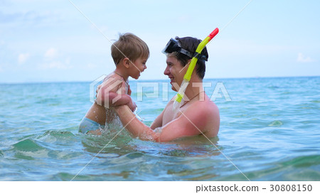 a guy with kid plays having fun in the sea a guy with kid plays having fun in the sea 30808150
