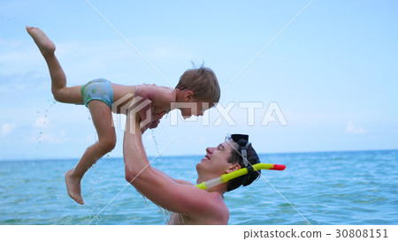 a guy with kid plays having fun in the sea a guy with kid plays having fun in the sea 30808151