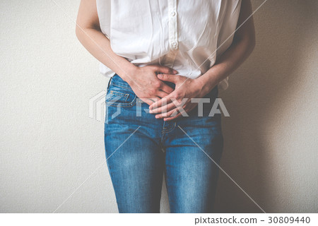 A woman holding the lower abdomen A woman holding the lower abdomen 30809440