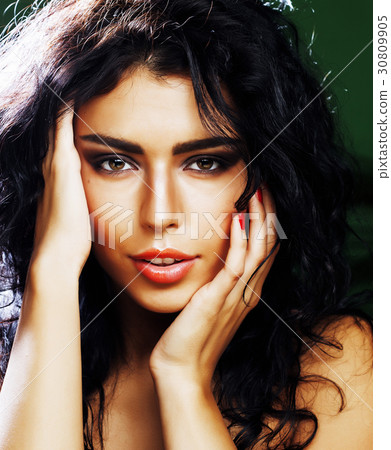 young smiling brunette woman on green background 30809905