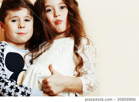 little cute boy and girl hugging playing on white 30809906