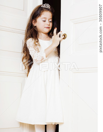little cute girl at home, opening door well 30809907