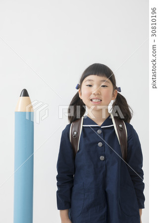 Huge pencil and elementary school student Huge pencil and elementary school student 30810196