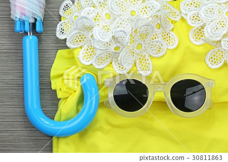Sunglasses on yellow vintage bikini and umbrella. Sunglasses on yellow vintage bikini and umbrella. 30811863