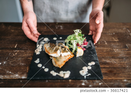 Chef decorate with vegetables dish of fried fish Chef decorate with vegetables dish of fried fish 30817421