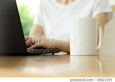 Businesswoman using tablet and drinking coffee Businesswoman using tablet and drinking coffee 30821365