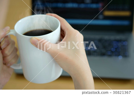 businesswoman drinking coffee and using laptop businesswoman drinking coffee and using laptop 30821367