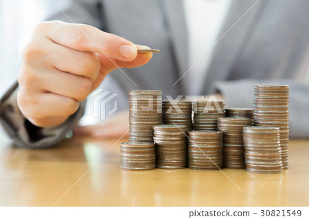 businesswoman put coins to stack of coins businesswoman put coins to stack of coins 30821549