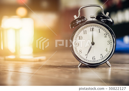 7 o'clock time retro clock on wood table 7 o'clock time retro clock on wood table 30822127