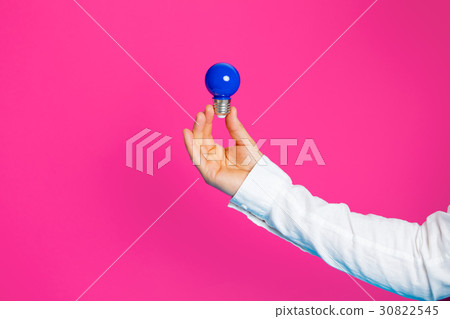 photo of male hand holding blue bulb 30822545