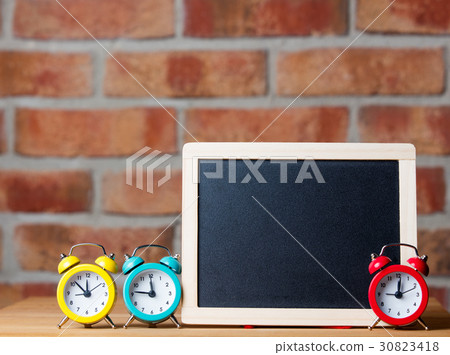 alarm clocks and blackboard alarm clocks and blackboard 30823418