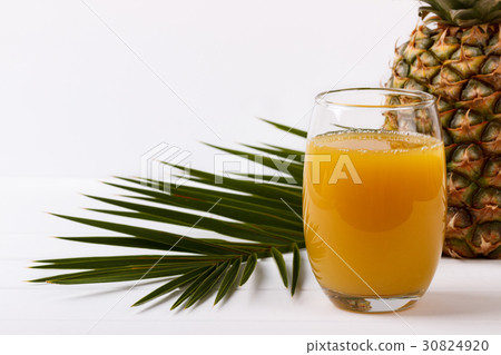 glass of pineapple juice 30824920